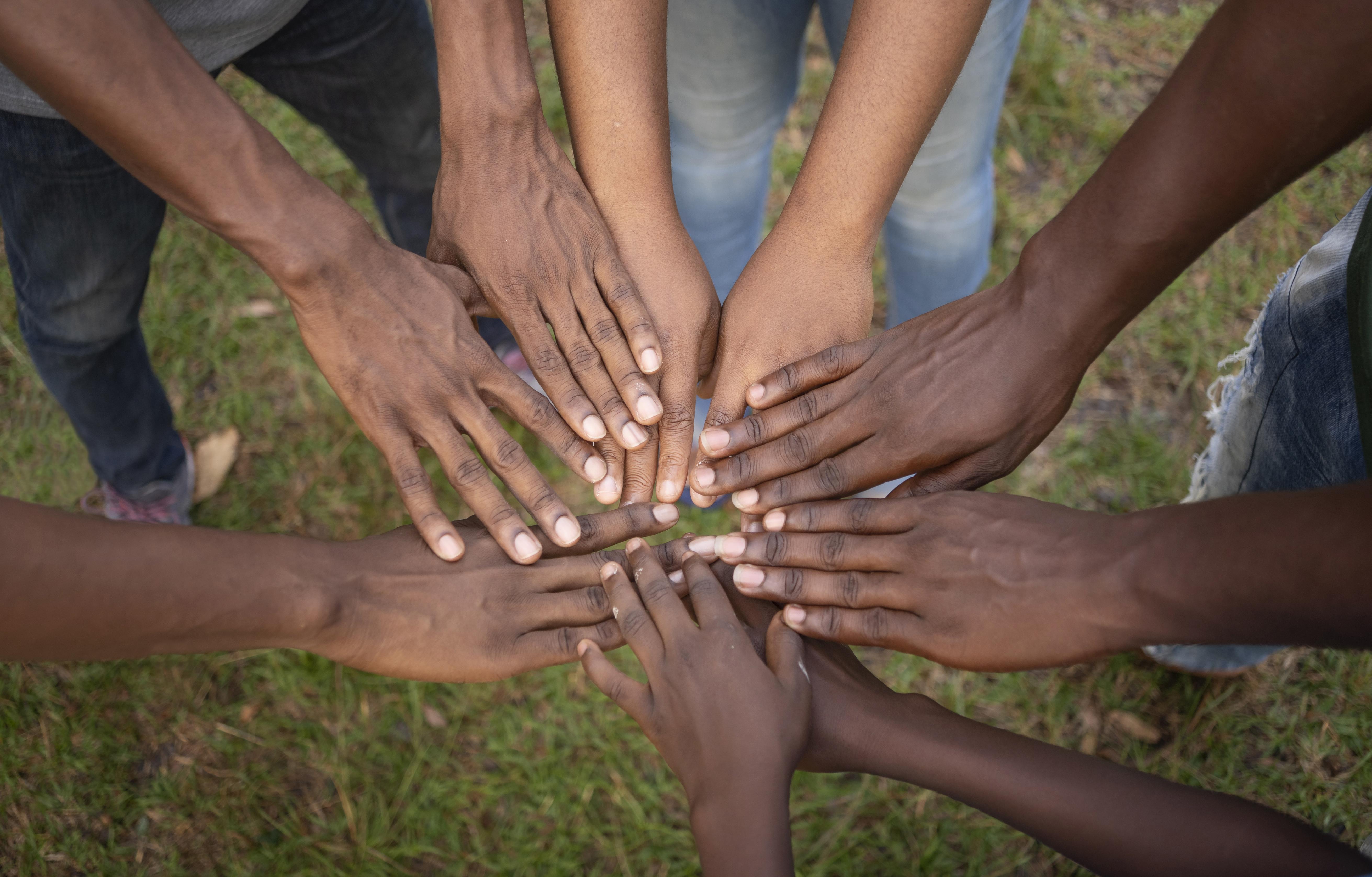 Community members joining hands together